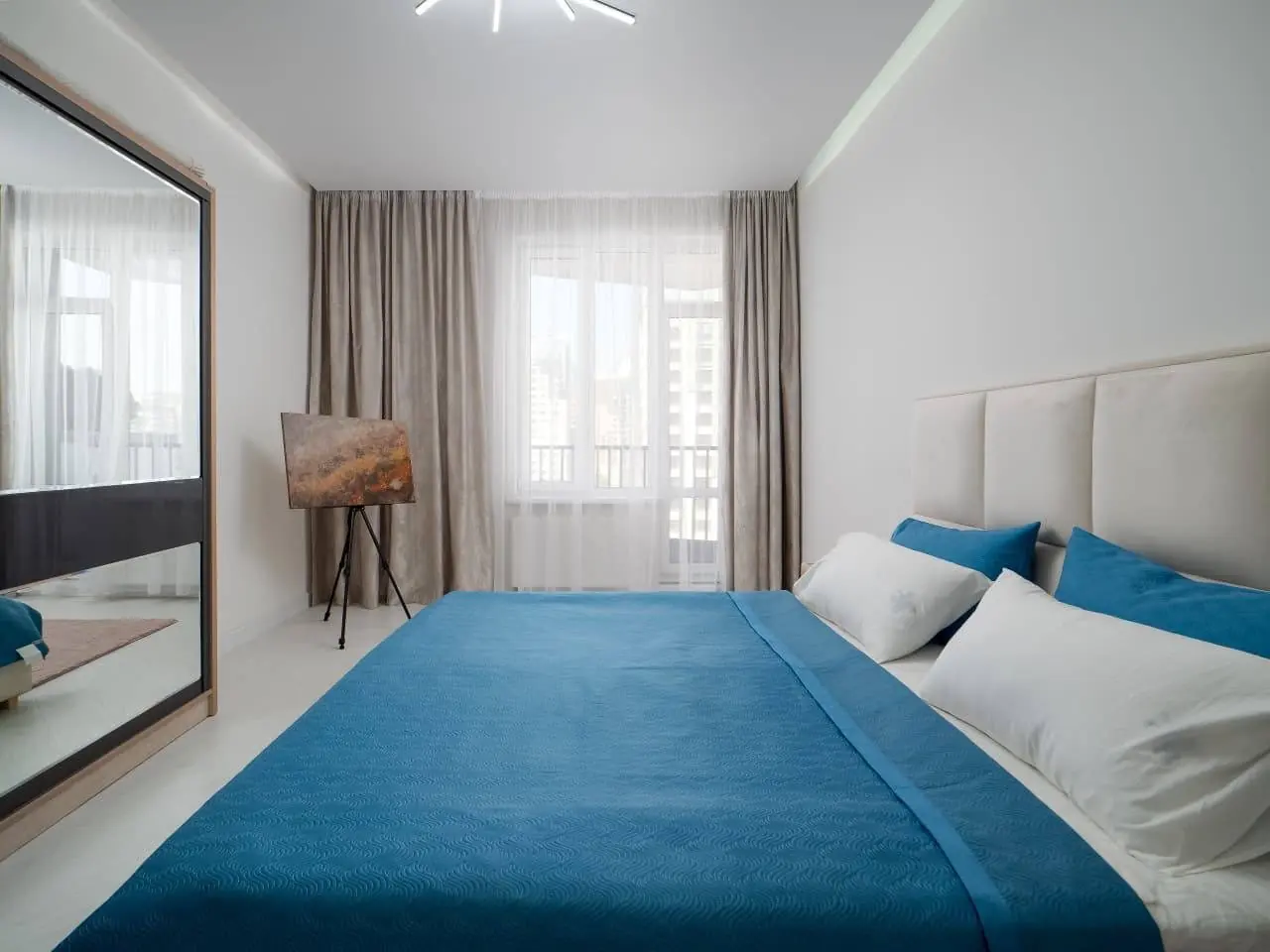 Bedroom with grey curtains and TV